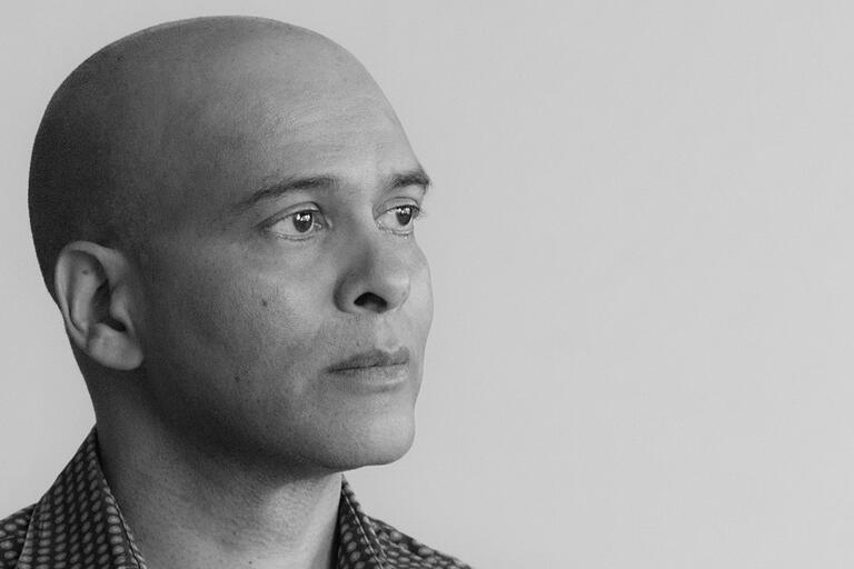 A black and white portrait of Al-An deSouza